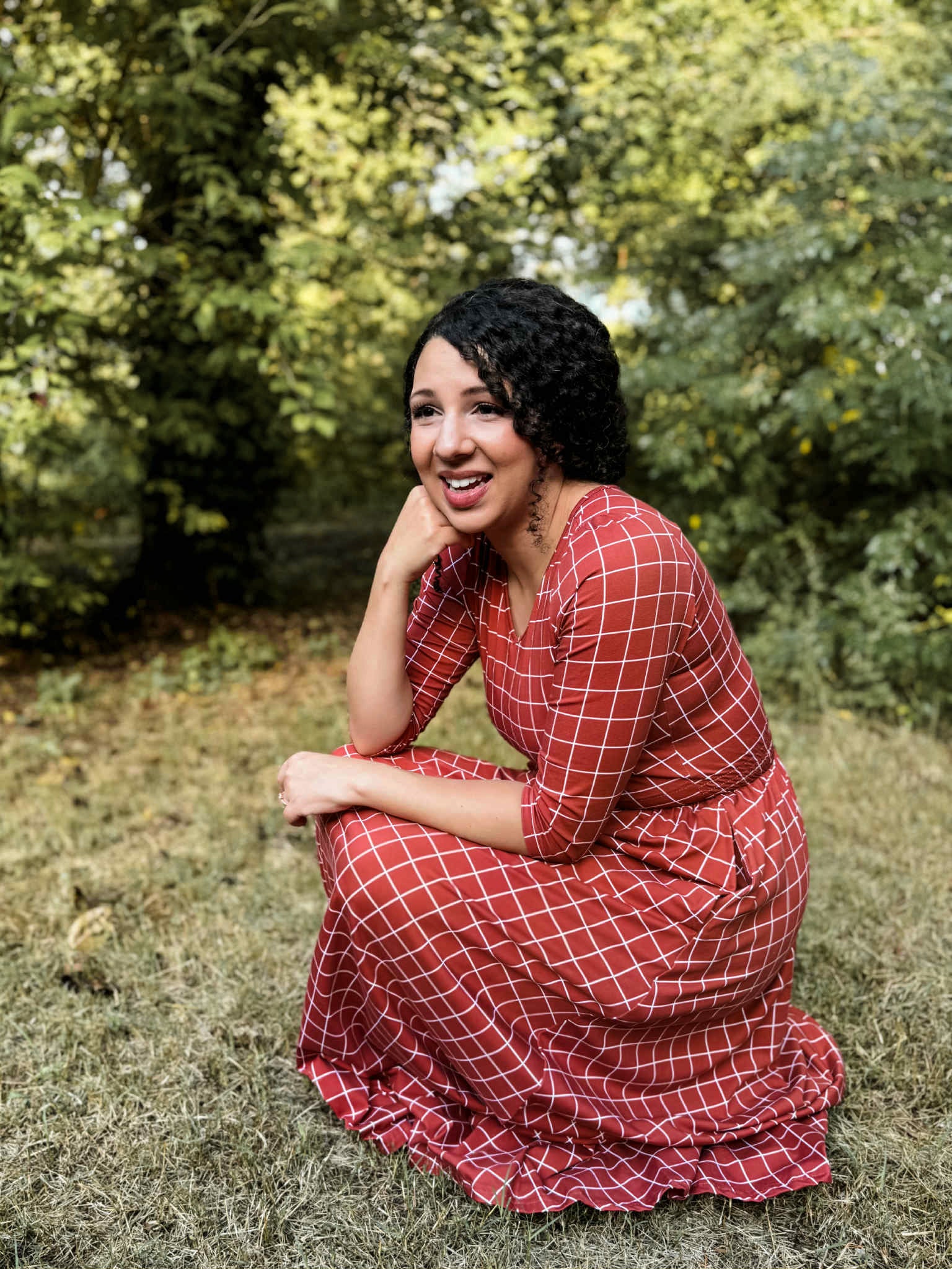 Woman in modest nursing copper windowpane dress outdoors