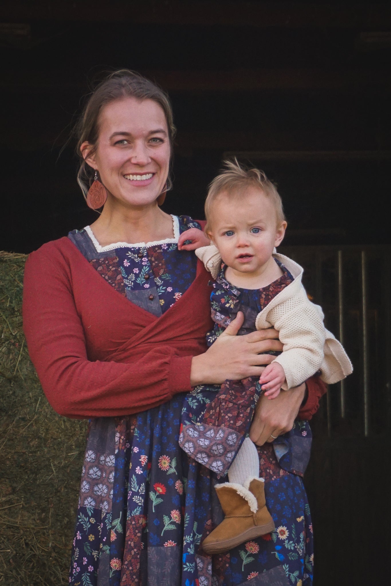 mother wearing a modest nursing patterned dress with her daughter