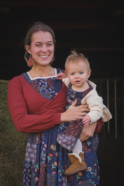 mother wearing a modest nursing patterned dress with her daughter