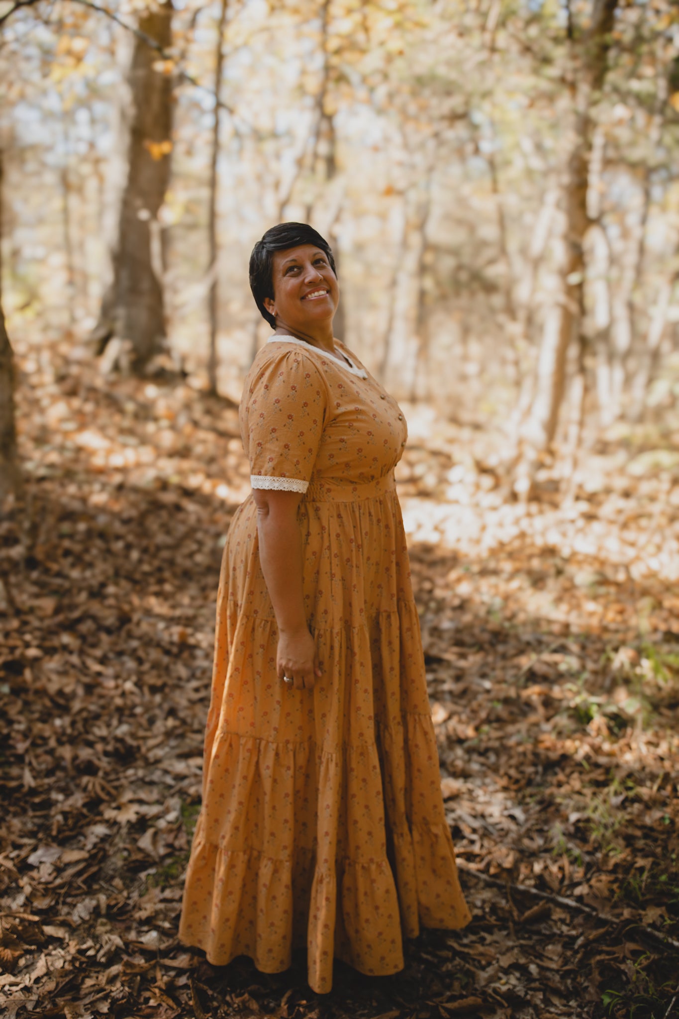 Woman in modest nursing dress forest leaves