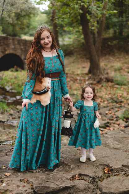 Two women wearing modest nursing dresses outdoors together.