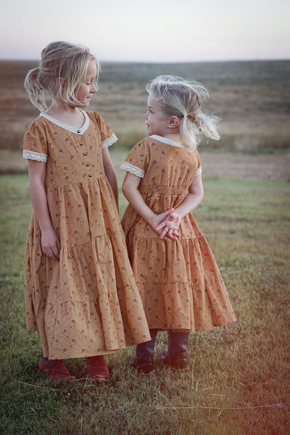 Two young girls in modest matching dresses