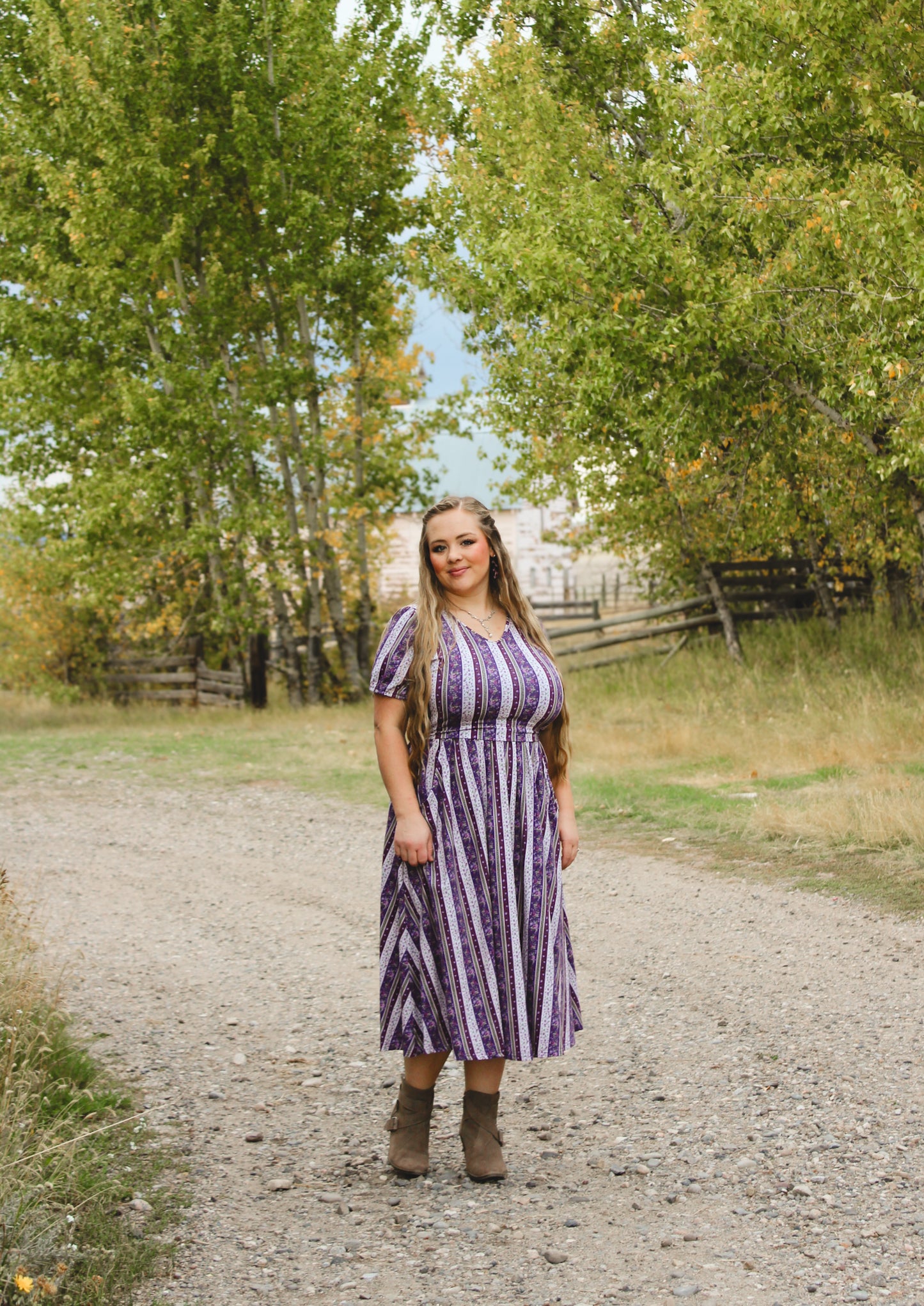 woman wearing a modest nursing purple and white striped dress