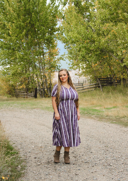 woman wearing a modest nursing purple and white striped dress