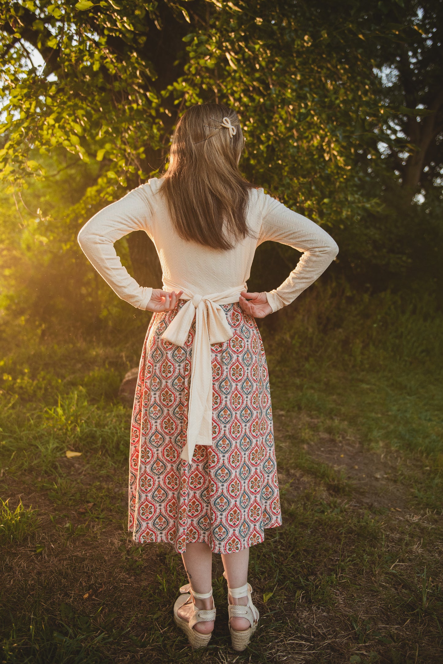 Woman in modest nursing dress in sunlit forest