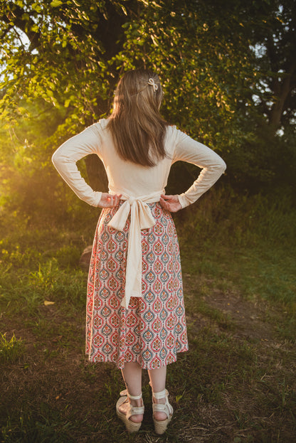Woman wearing a patterned modest nursing dress