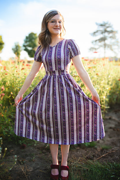 woman wearing a modest nursing purple and white striped dress