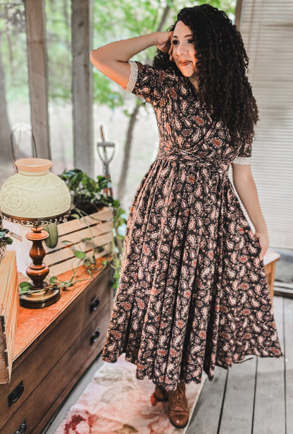 Woman in modest nursing dress indoors with plants