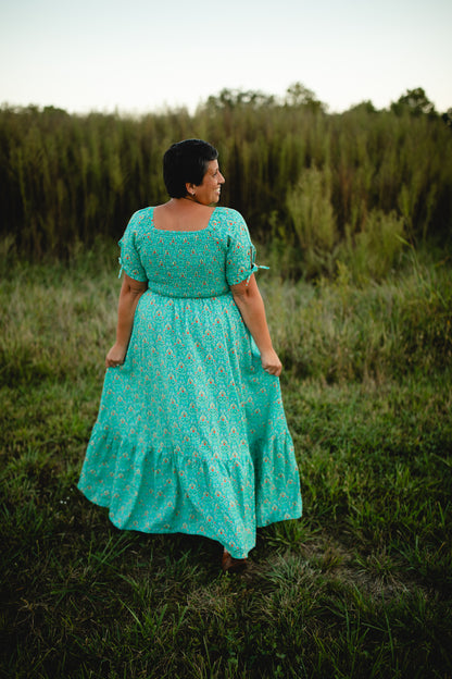 Woman in modest nursing teal dress standing