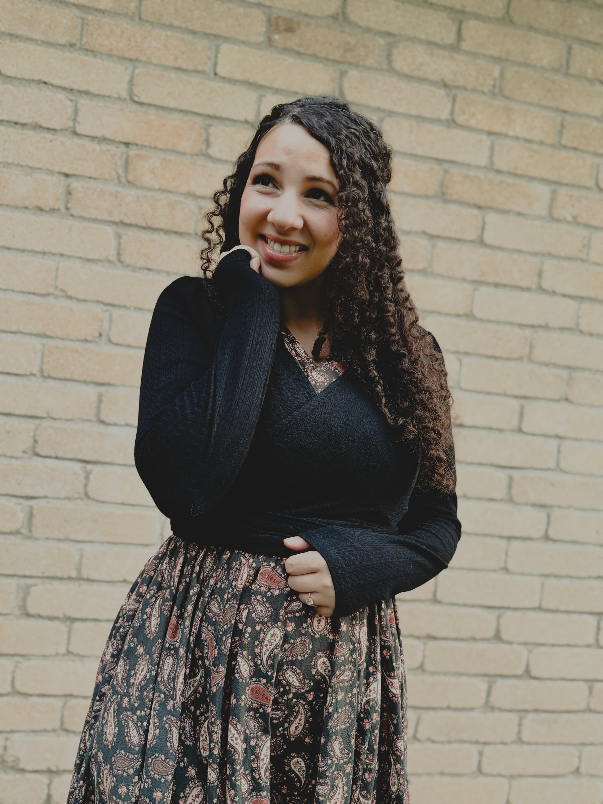 woman wearing a modest nursing black patterned dress