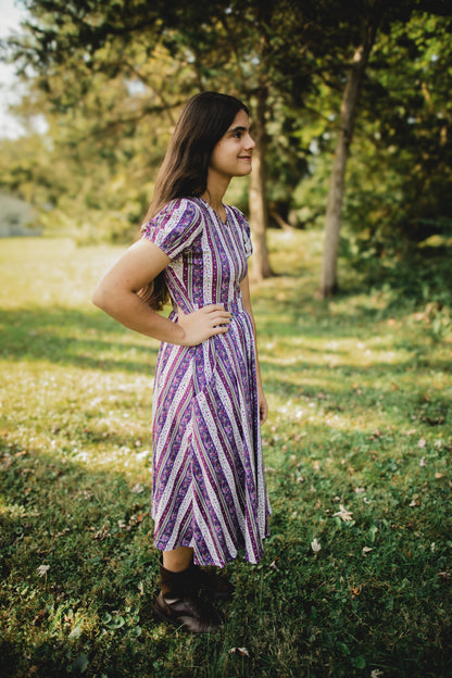 woman wearing a modest nursing purple and white striped dress