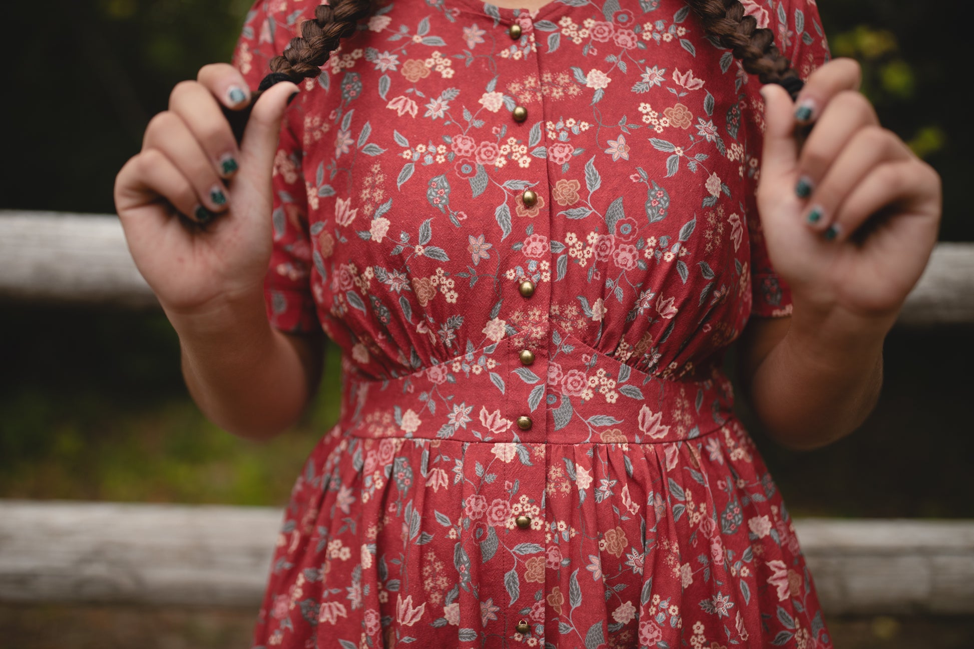 Woman in modest nursing red floral dress