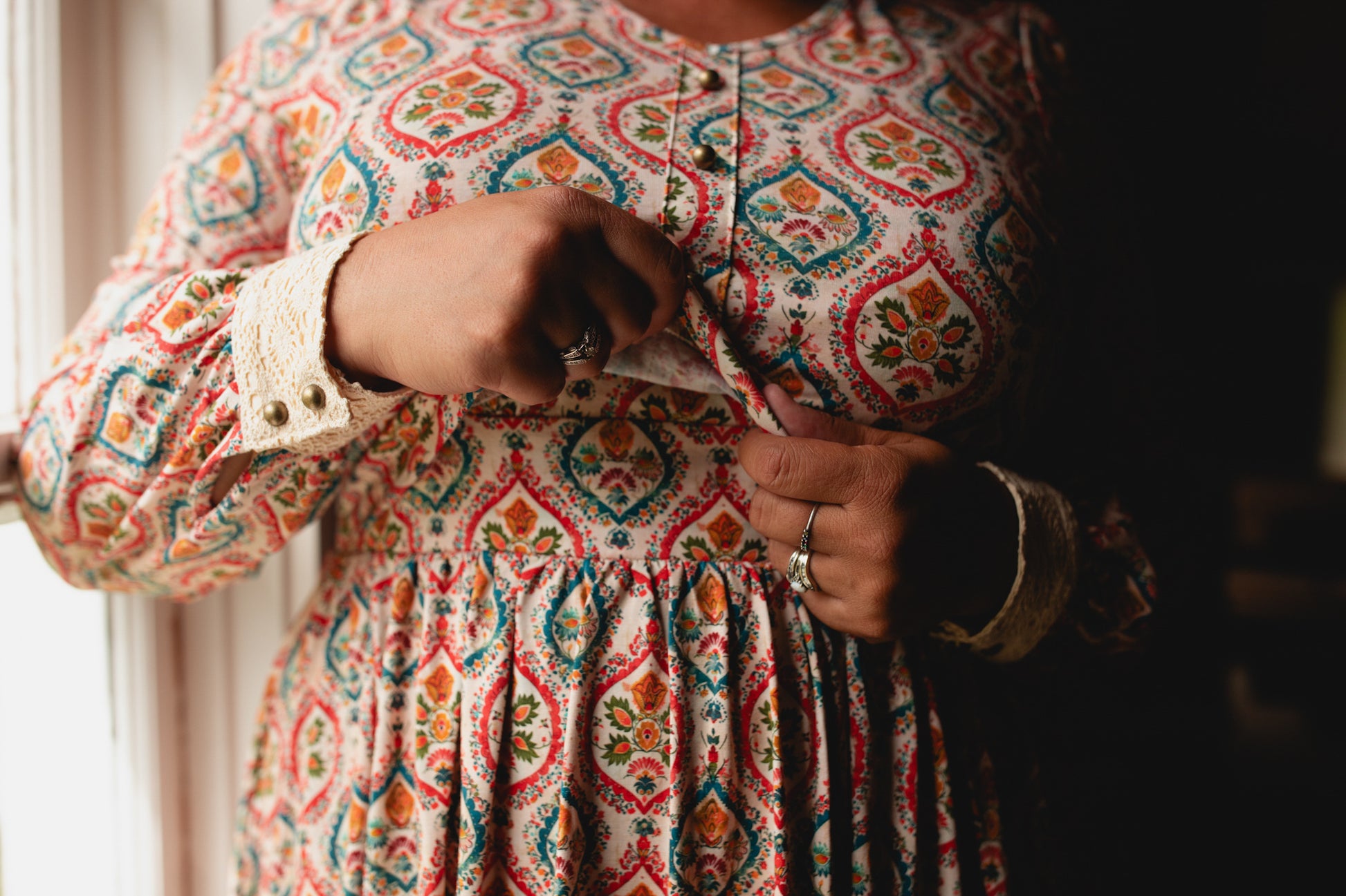 Woman wearing a patterned modest nursing dress