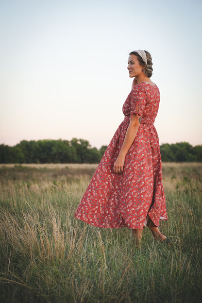 Woman in modest nursing red floral dress outdoors