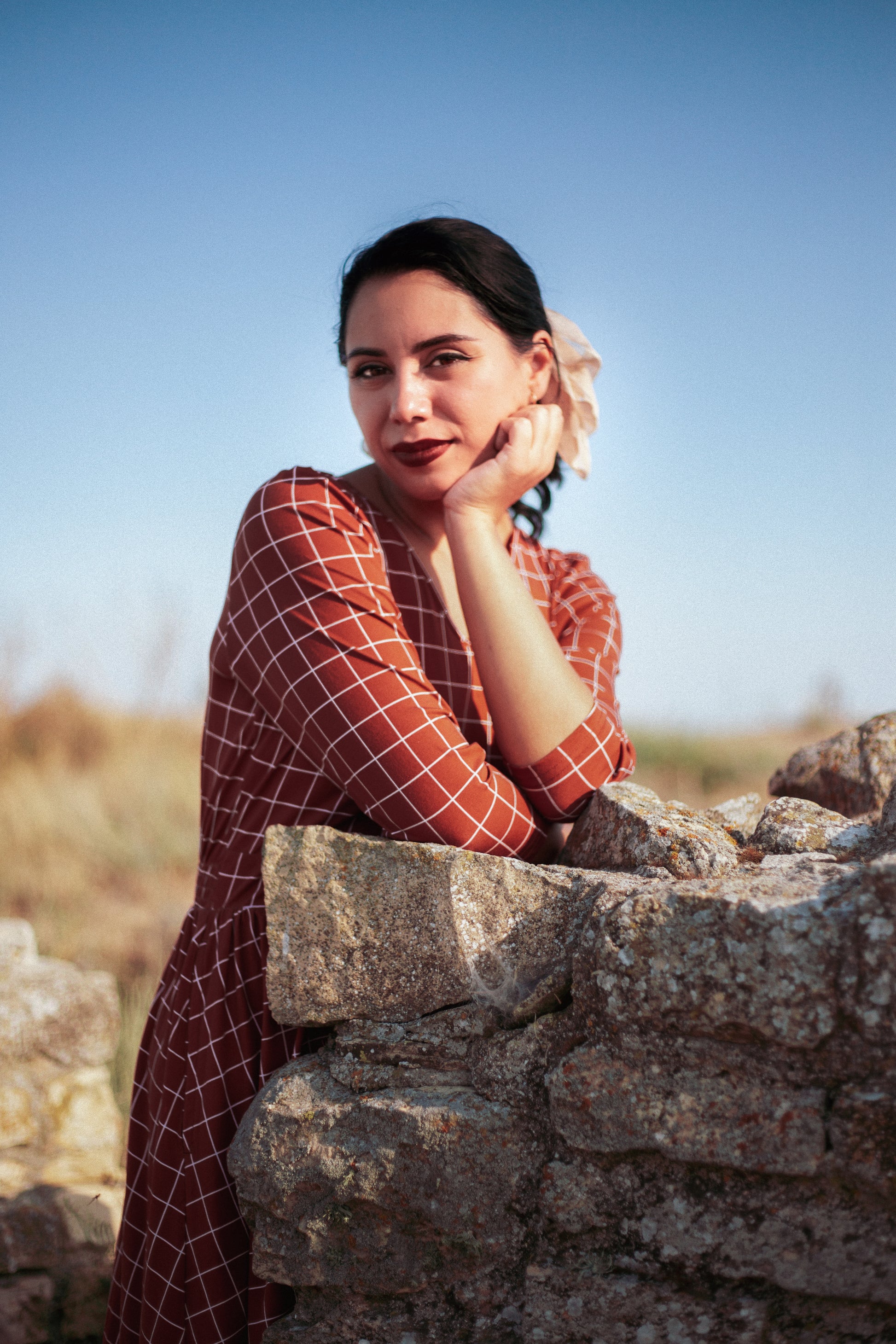 Woman in modest nursing copper windowpane dress