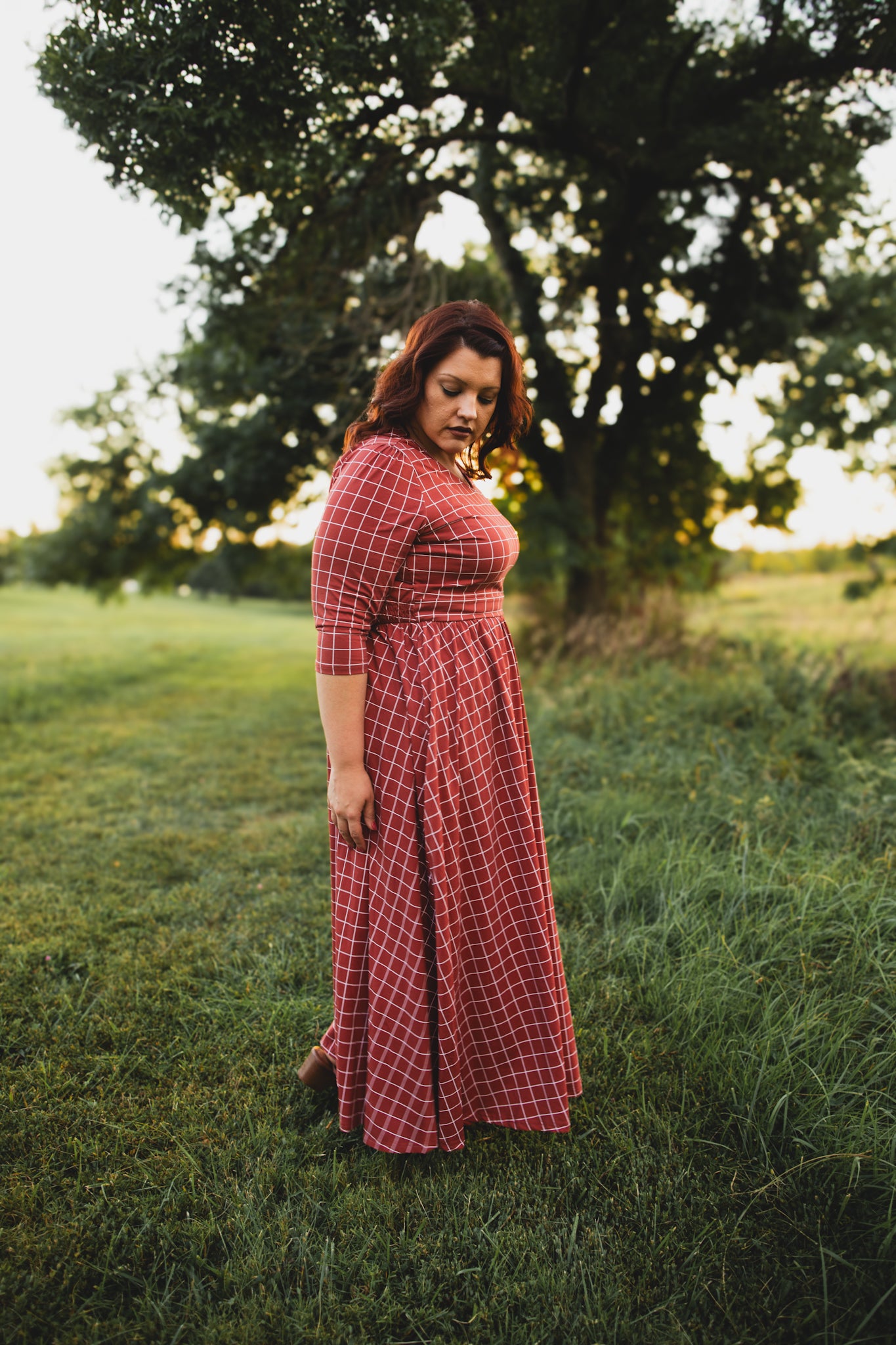 Woman in modest nursing copper dress field