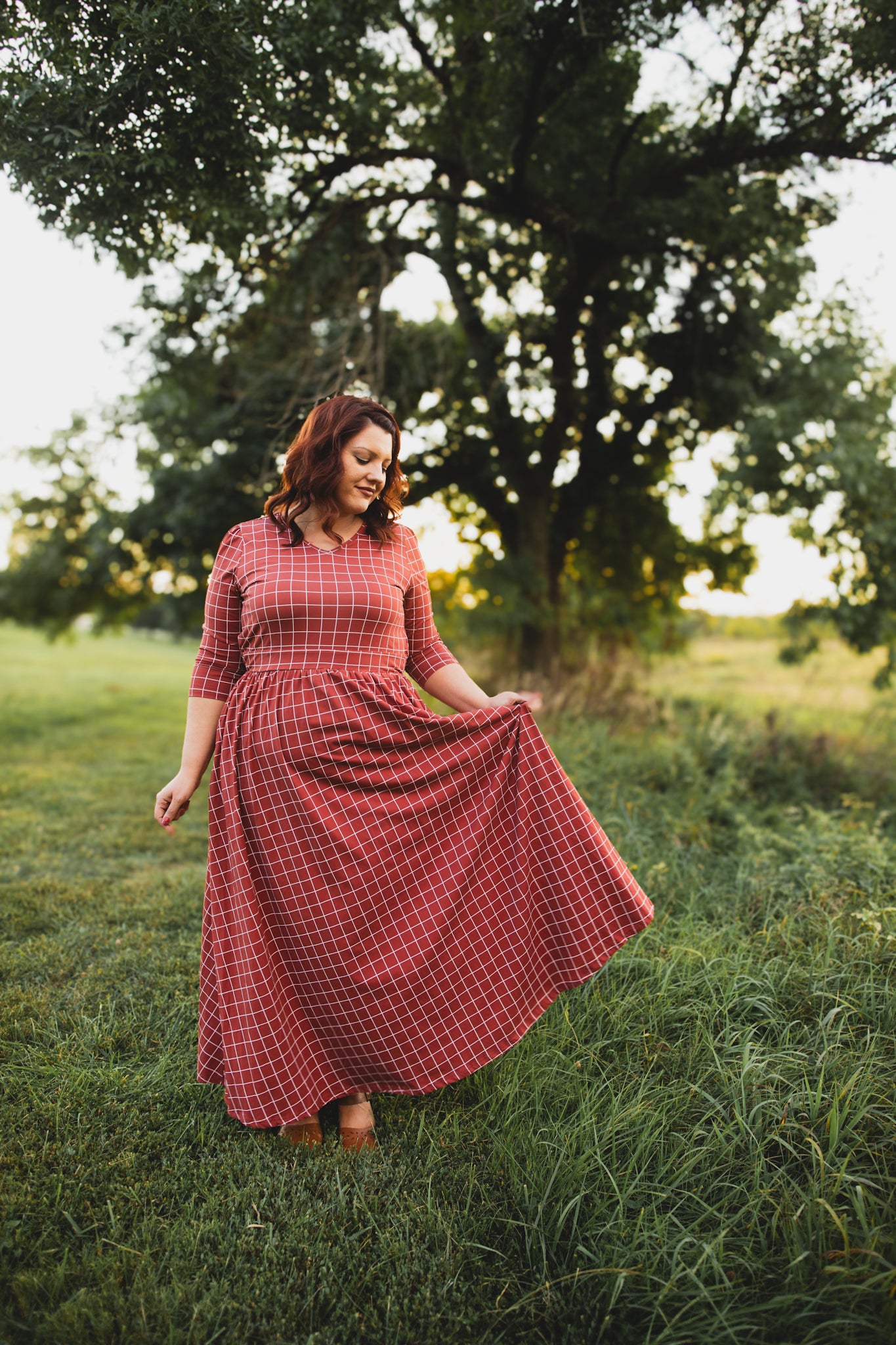 Woman in modest nursing copper windowpane dress