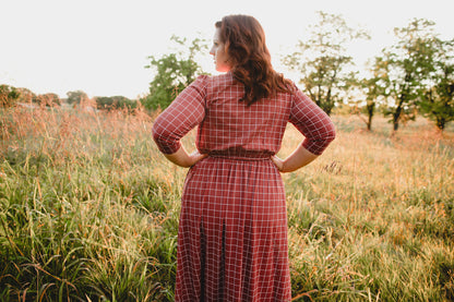Woman in modest nursing copper windowpane maxi dress 