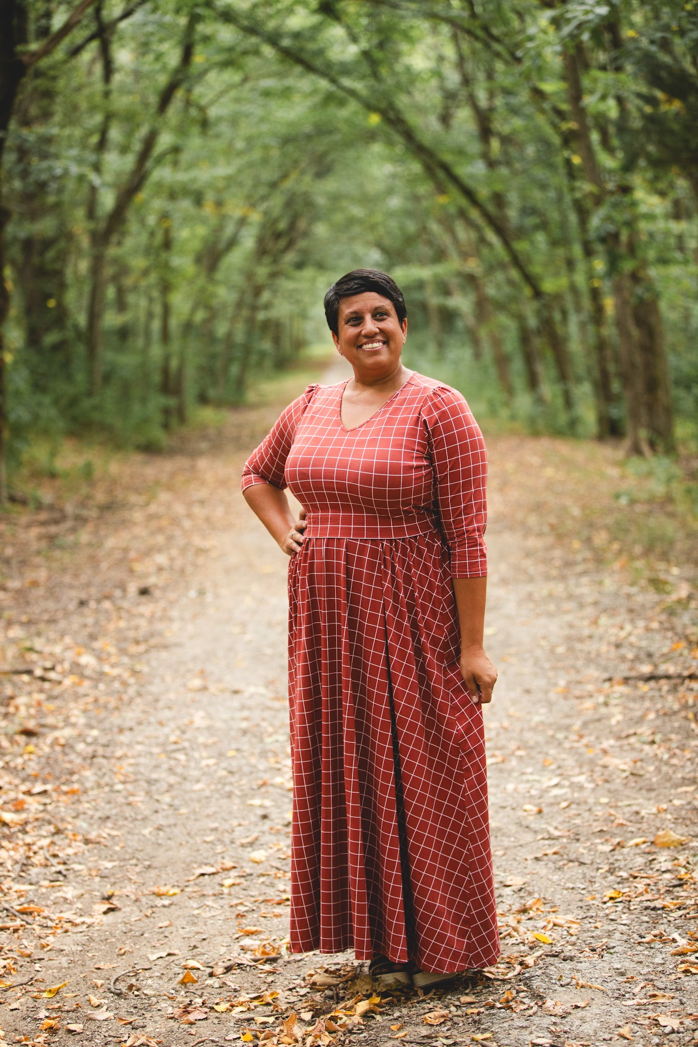 Woman in modest nursing copper windowpane dress