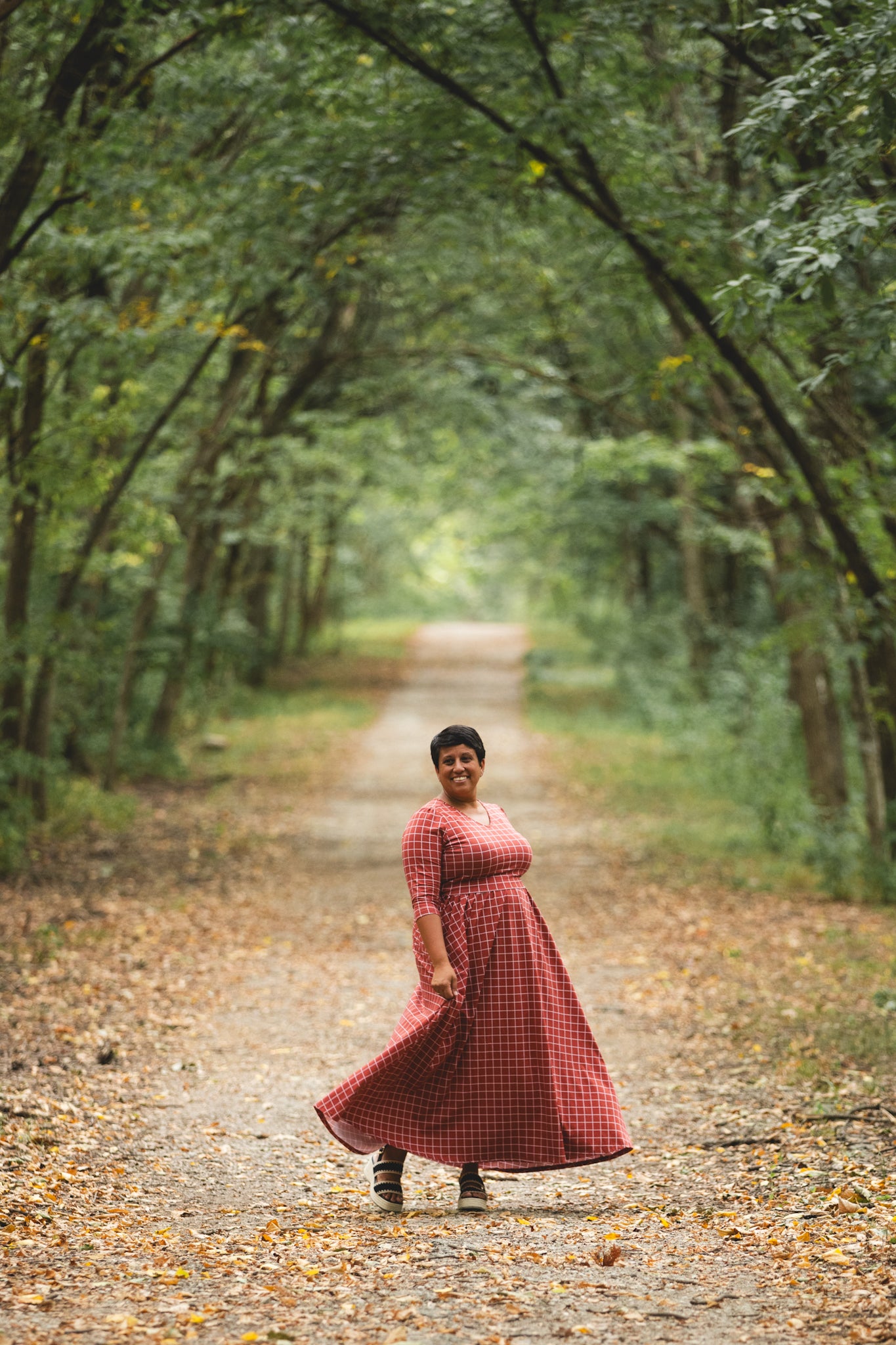 Woman wearing modest nursing copper dress on pathway