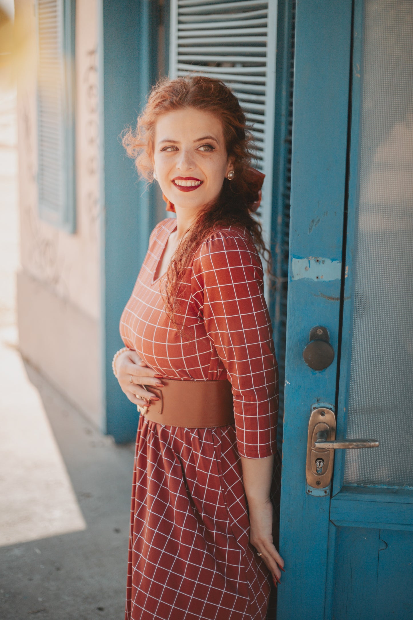 Woman in modest nursing copper windowpane maxi dress 