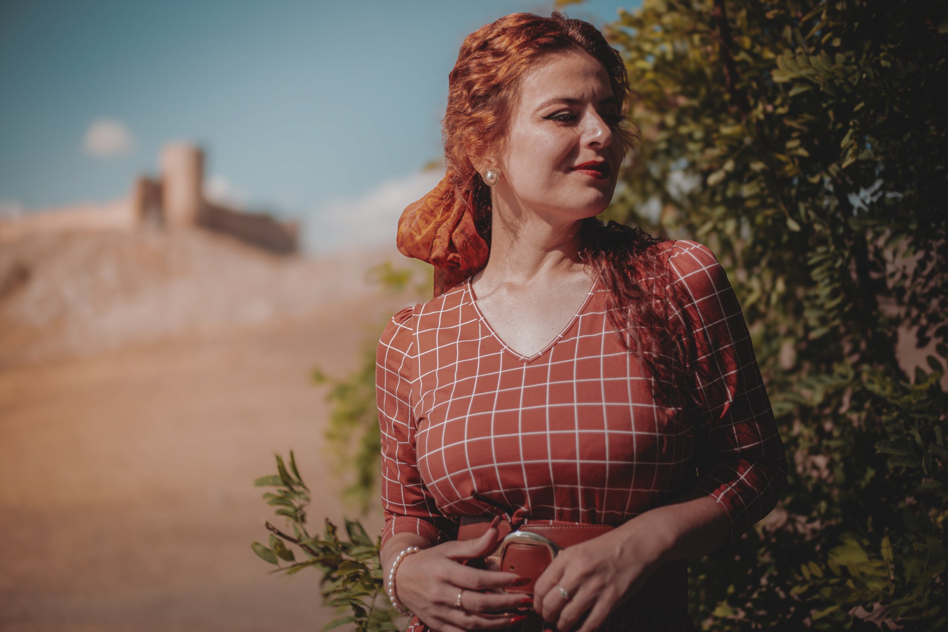 Woman in modest nursing copper windowpane dress