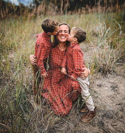 Mother in modest nursing dress with two children outdoors