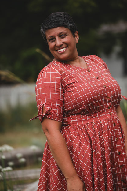 Woman in modest nursing checkered dress outdoors