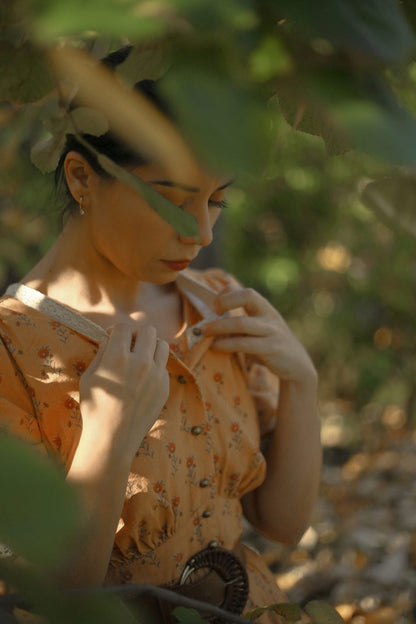 Woman in modest nursing dress among greenery