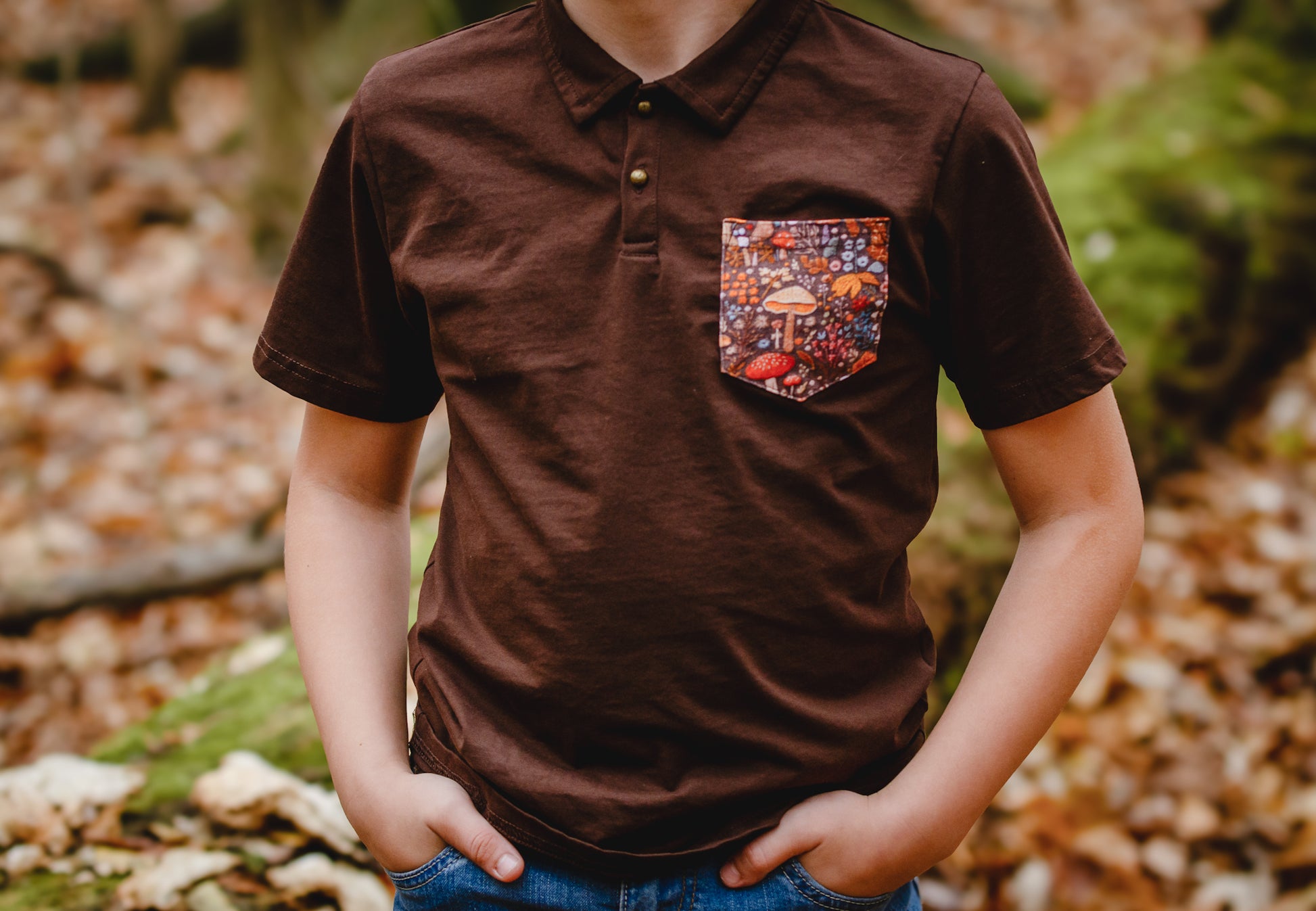 Boy wearing brown polo with colorful pocket