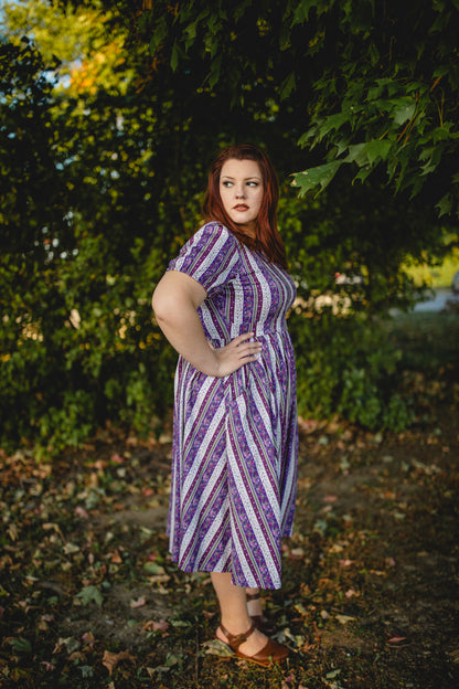 woman wearing a modest nursing purple and white striped dress