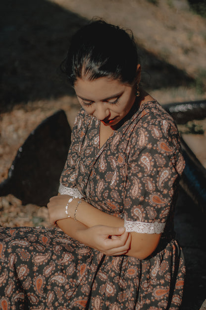 woman wearing a modest nursing black patterned dress