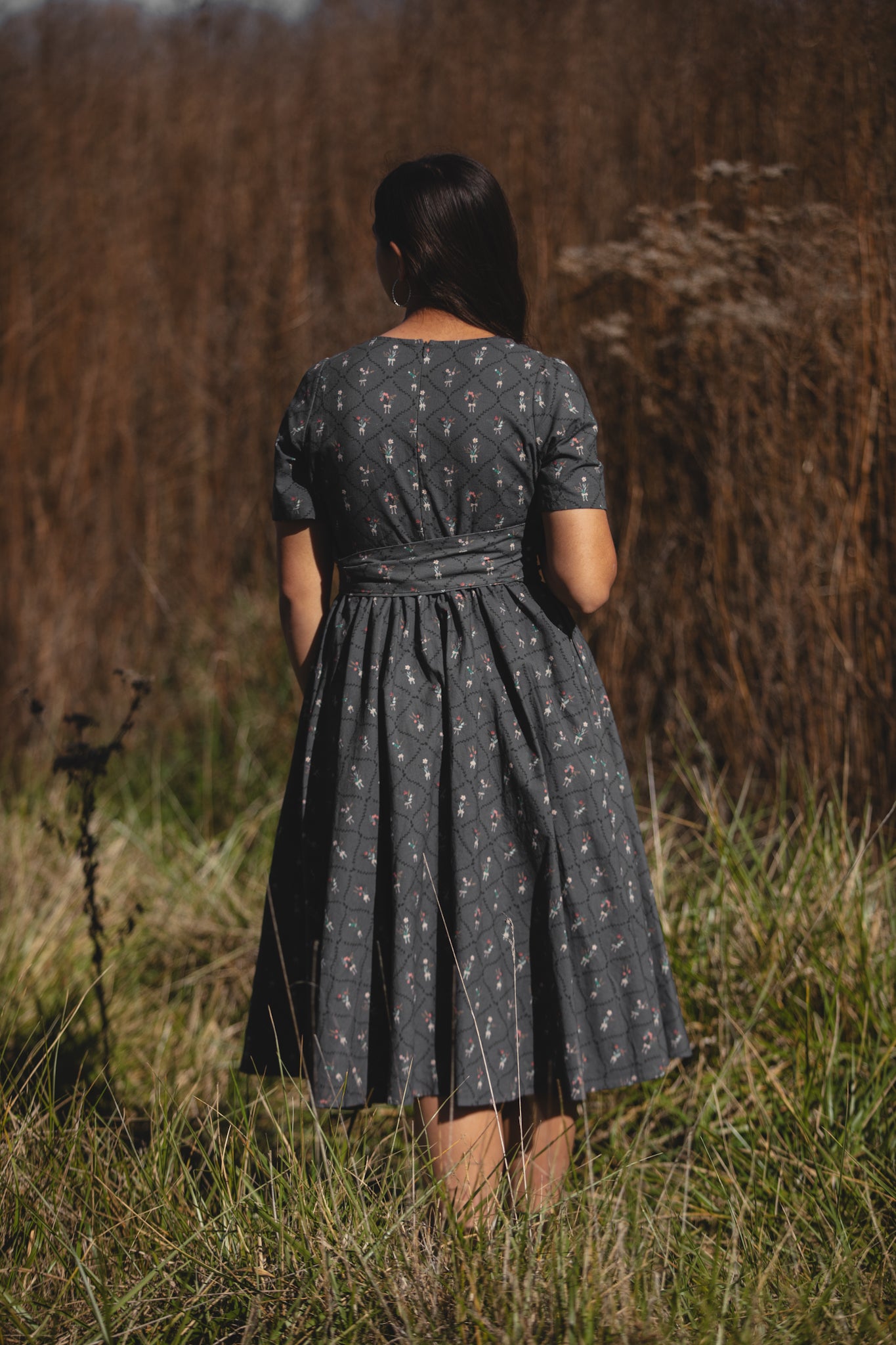 Modest dark patterned dress in field