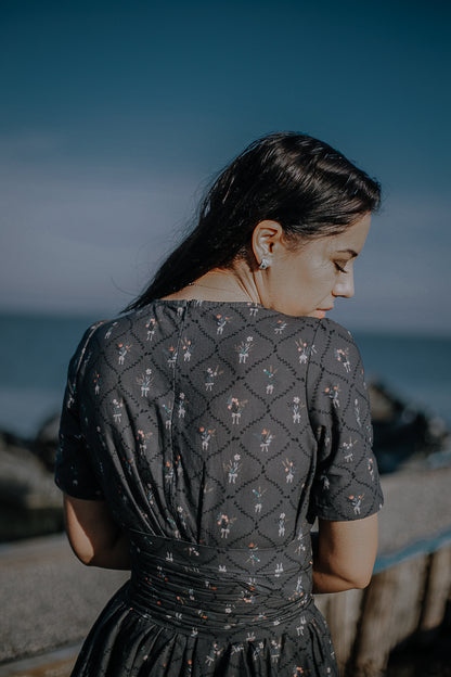 Modest nursing-friendly dark dress by water