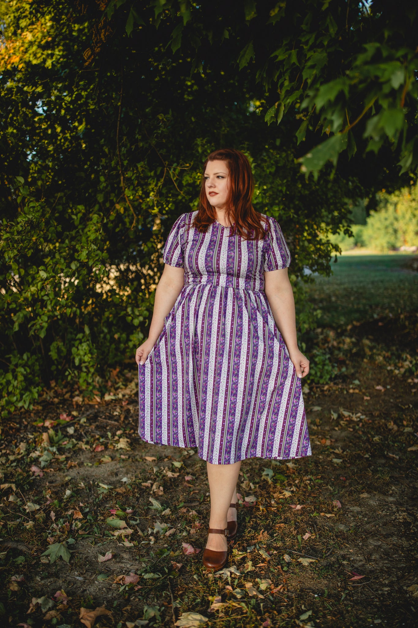 woman wearing a modest nursing purple and white striped dress