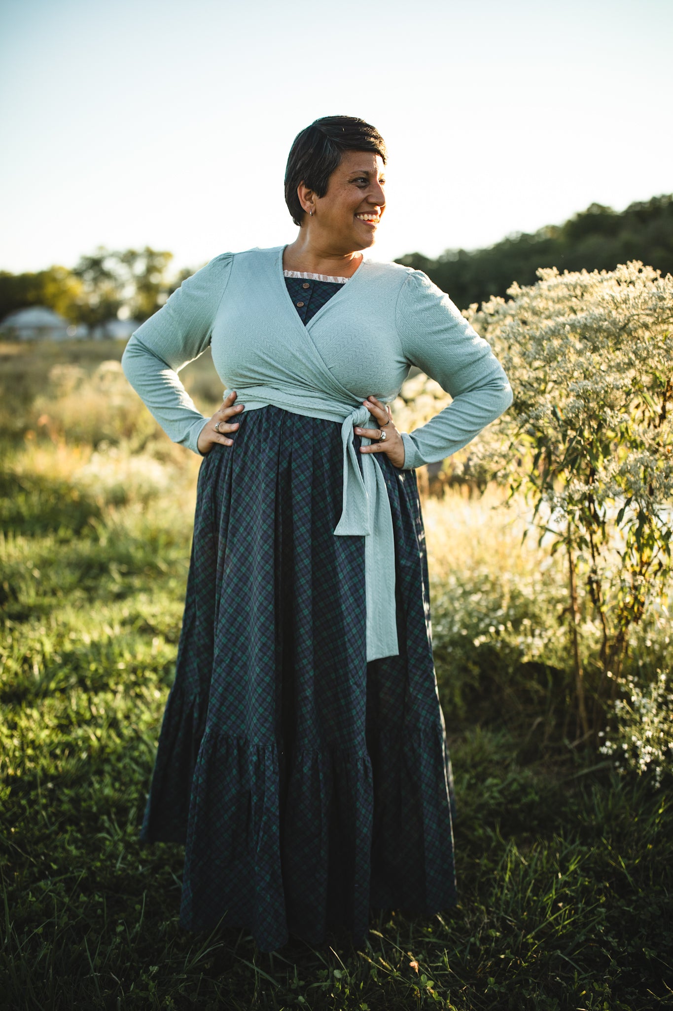 Woman in modest nursing wrap and green dress
