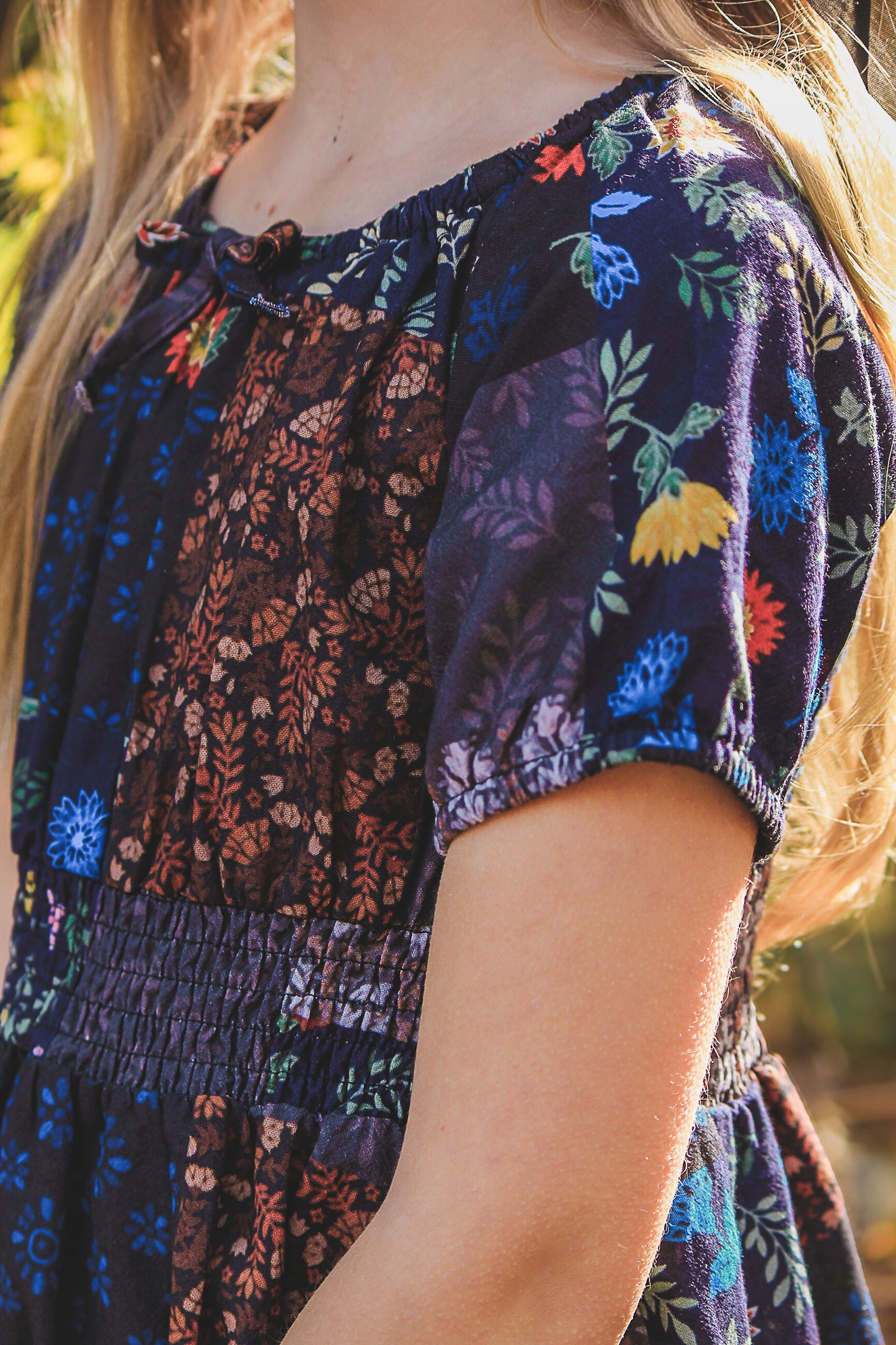 young girl wearing a cute patchwork dress
