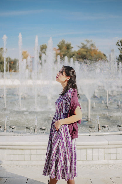 woman wearing a modest nursing purple and white striped dress