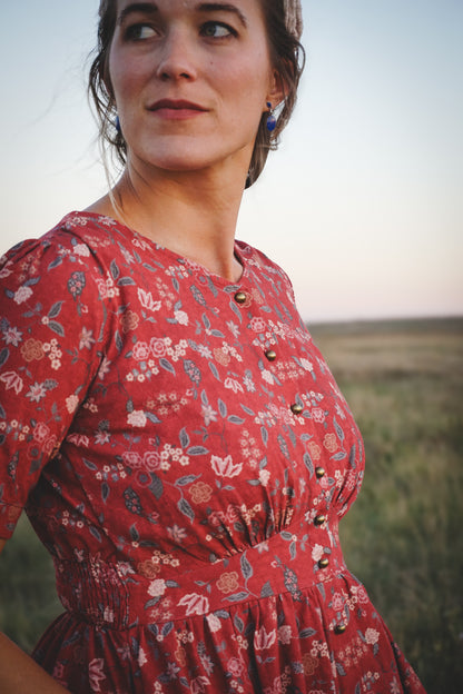 Woman in modest nursing red floral dress outdoors