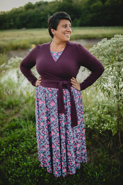Woman in modest nursing wrap over floral dress