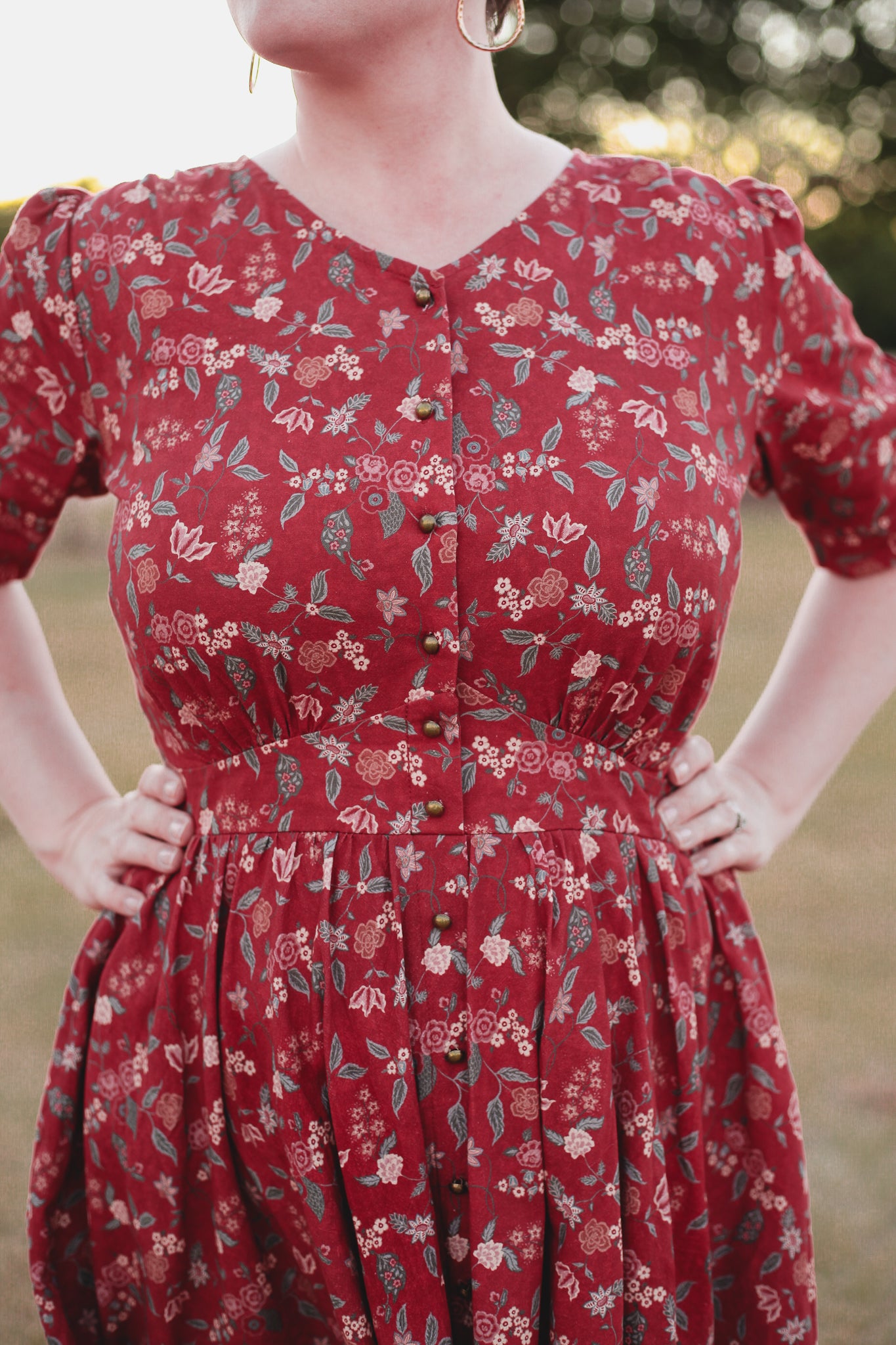 Woman in modest nursing red floral dress outdoors