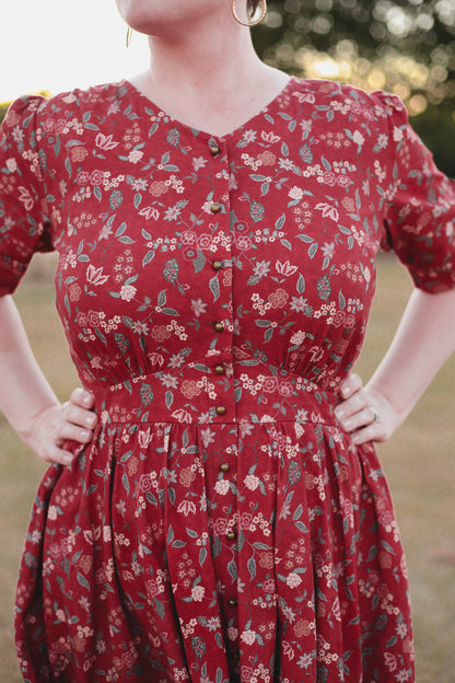 Woman in modest nursing red floral dress outdoors