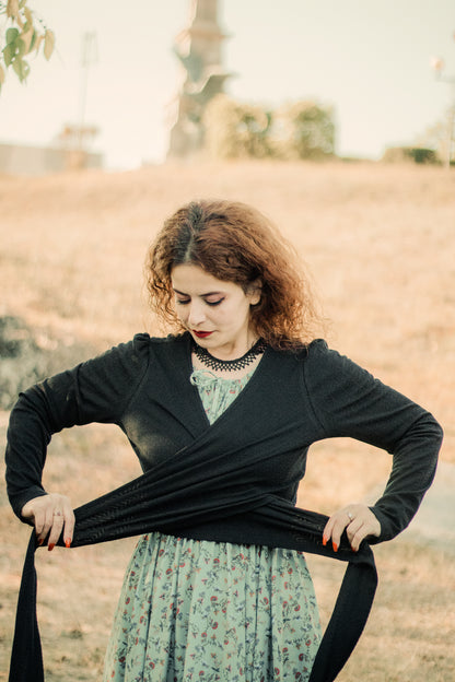 Woman in modest nursing-friendly cardigan over floral dress outdoors