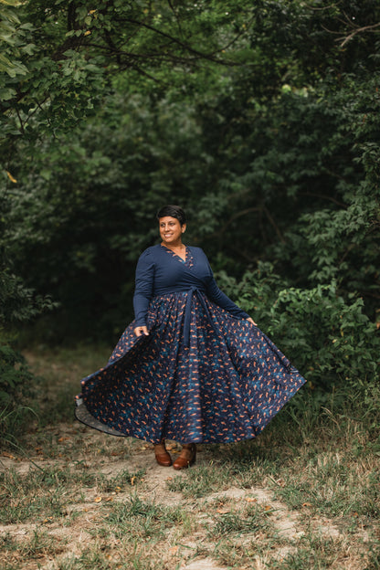Woman in modest nursing-friendly long dark blue patterned dress
