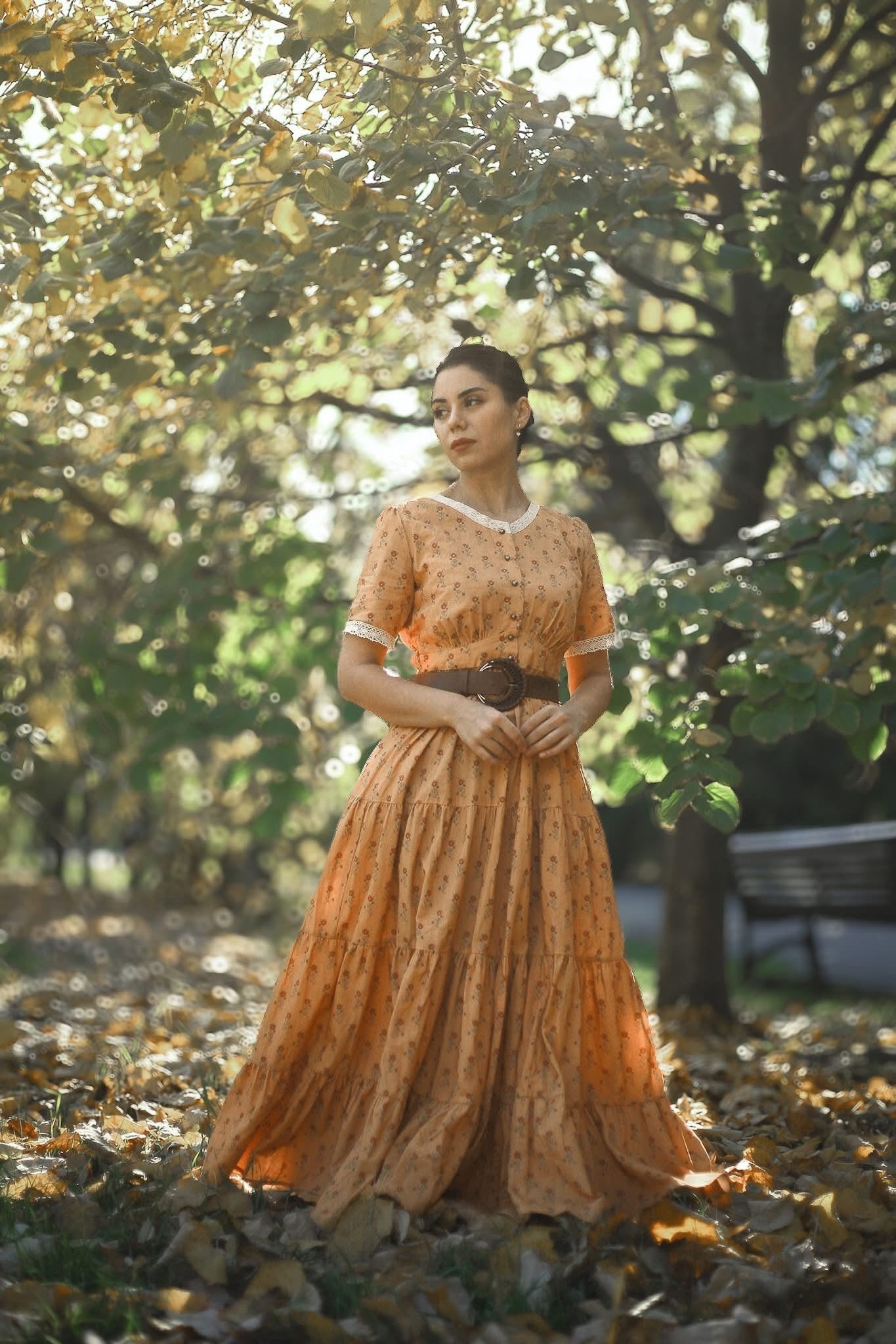 Woman in modest nursing dress park autumn leaves