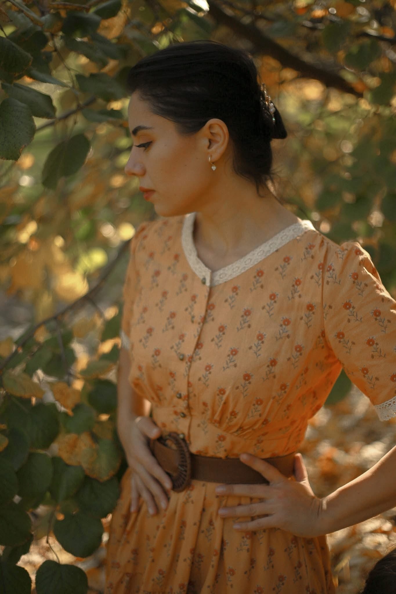 Woman in modest nursing dress among trees