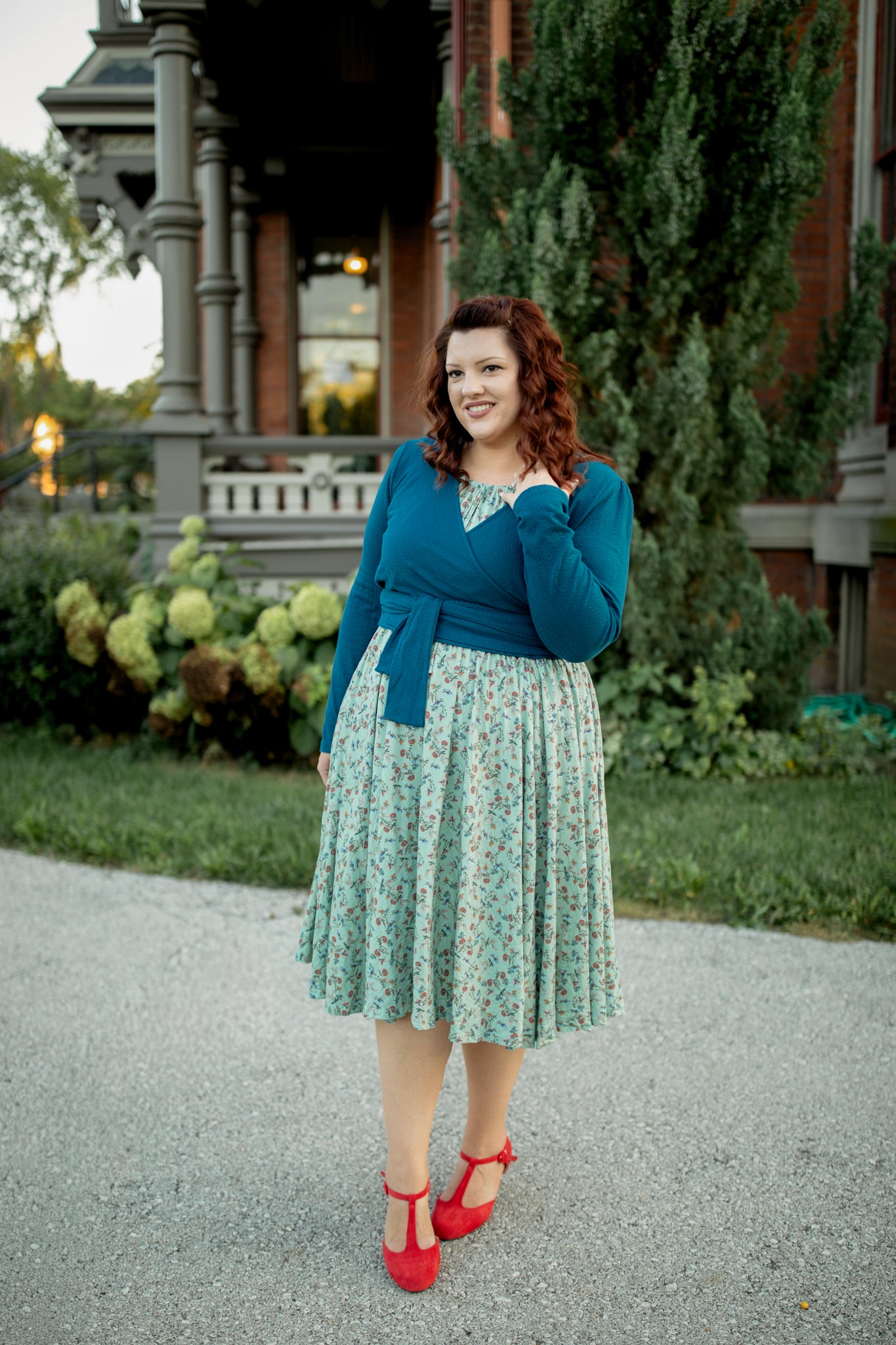Woman in blue cardigan and floral skirt