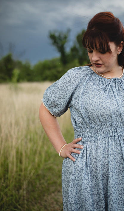 woman in a modest blue nursing dress