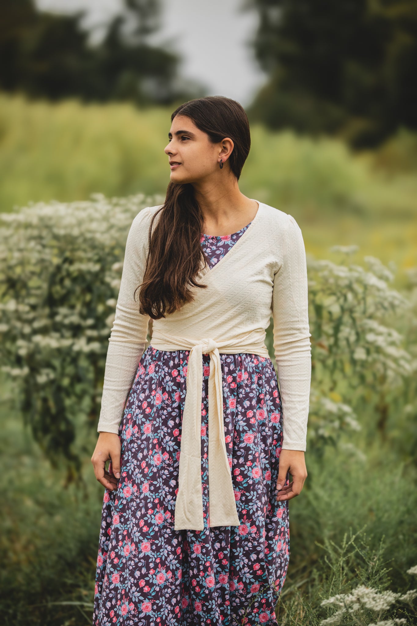 Woman in modest nursing dress with cardigan outdoors