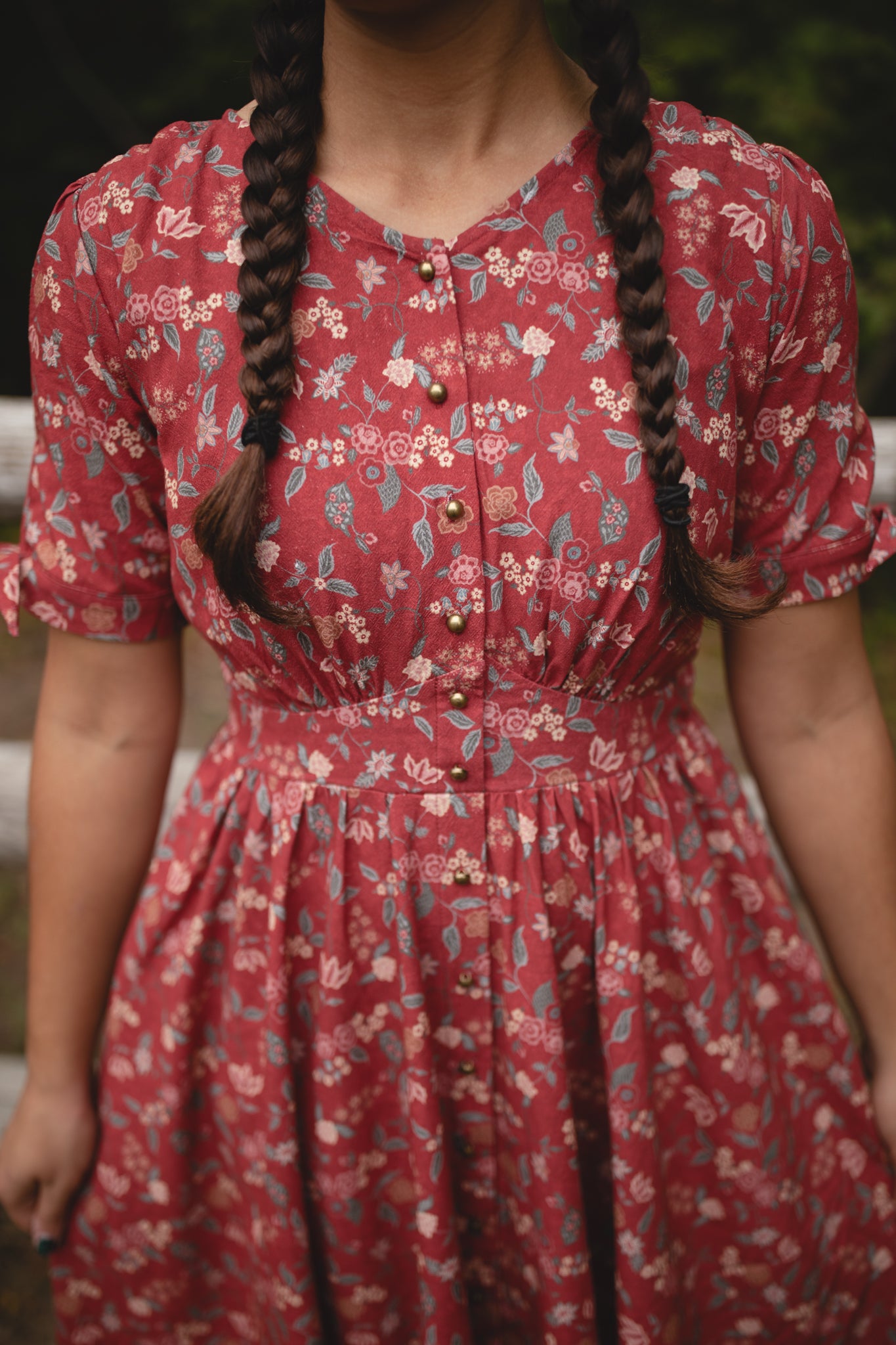 Woman in modest nursing red floral dress outdoors
